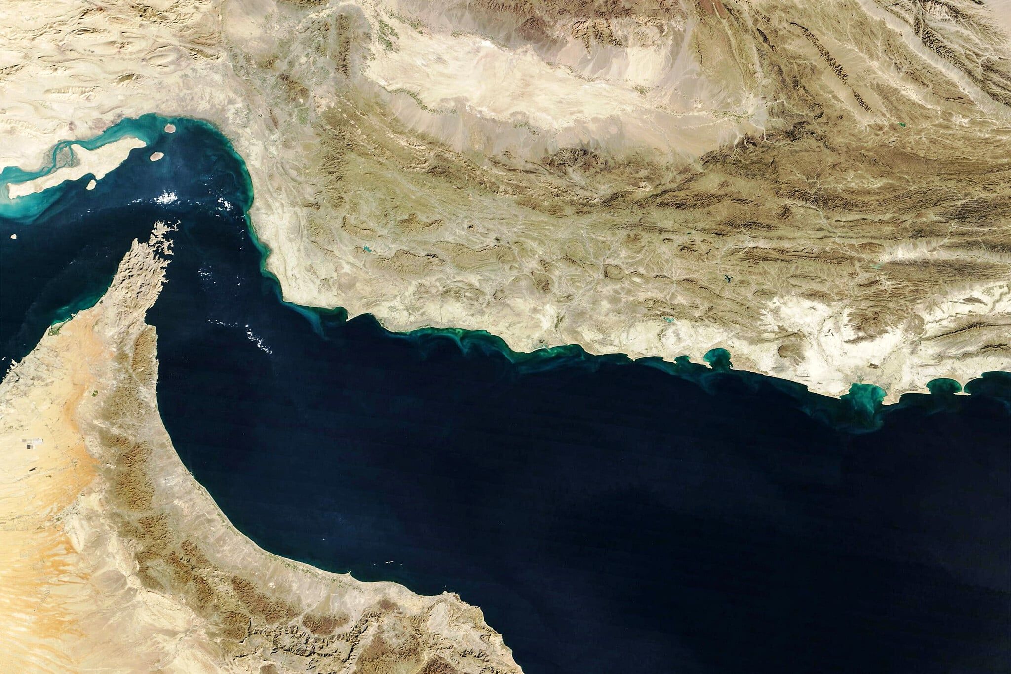 This handout natural-color image acquired with MODIS on NASA's Terra satellite taken on February 5, 2025, shows the Gulf of Oman and the Strait of Hormuz (upper left). (NASA Earth Observatory / AFP) Share