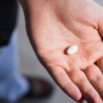 Man-Holding-White-Pill-Crop